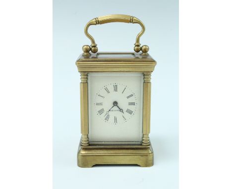 A mid 20th Century diminutive brass carriage clock, key wind and set, the case having hexagonal corner columns and bevelled g