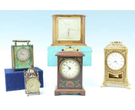 Five clocks comprising, a Belle Epoque fruitwood mantle clock, having polychrome transfer decorated front, a brass carriage s