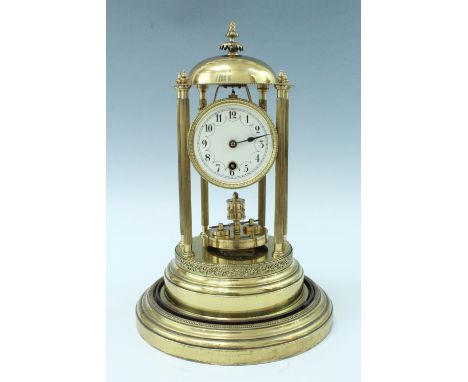 A large lacquered brass torsion clock, comprising a cylindrical movement with a disc pendulum and having a white dial, in a d