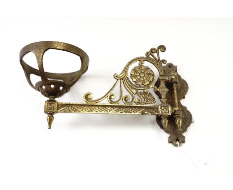 An early 20th Century Aesthetic influenced cast brass, hinged, oil lamp bracket, 31 cm from wall to centre of holder