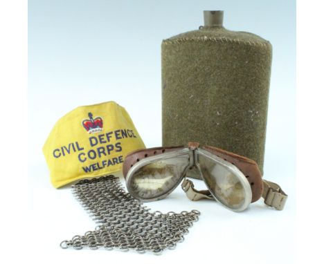 A set of Second World War British army goggles, a water bottle, burnishing mail and Civil Defence Corps brassard