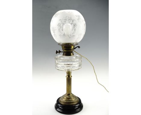A Victorian brass columnar oil lamp, having an etched shade and later converted to electricity, 55 cm