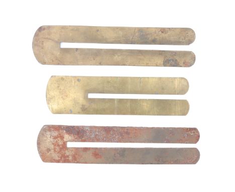 A police issue brass button stick by Hiatt, together with a War-economy steel clothing protector and one other button stick