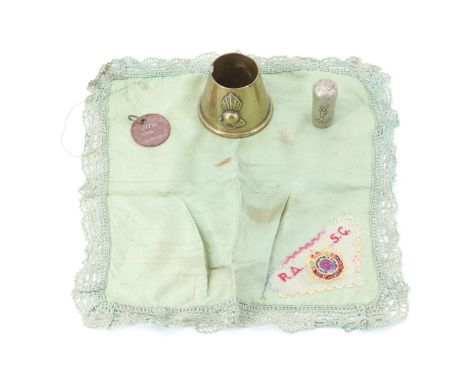 A Royal Army Service Corps sweetheart handkerchief together with a trench art ashtray, a Royal Signals swagger stick pommel a