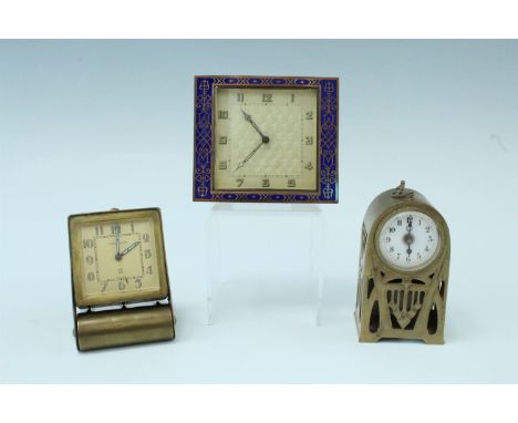 A 1930s Jaeger le Coultre travel alarm clock, having a 2 day movement in a rubbed brass electroplated folding case, an Art De
