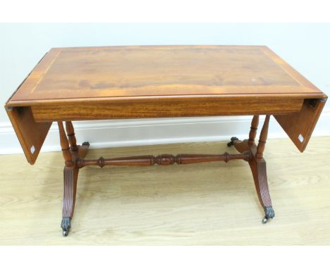 A modern yew veneered coffee table in the manner of a sofa table, 119 cm x 42 cm x 49 cm 