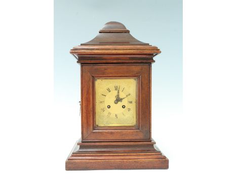 An early 20th Century post box form walnut mantle clock, having a French drum movement, striking on a bell, the dial having e