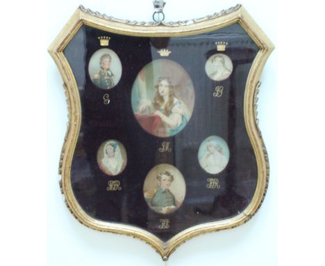 A 19th Century framed aristocratic family grouping of portrait miniatures, depicting Regency to Victorian military uniforms a