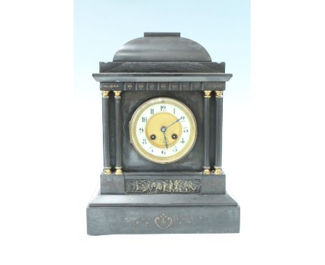 An early 20th Century architectural black slate mantle clock, having a French drum movement with a pendulum escapement striki