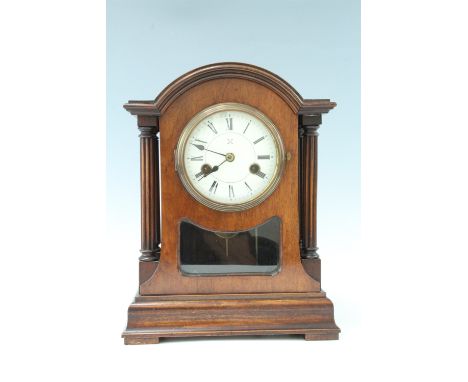 An early 20th Century German mantle clock, with brass movement, striking on a gong, domed top and free standing capitals, 26 