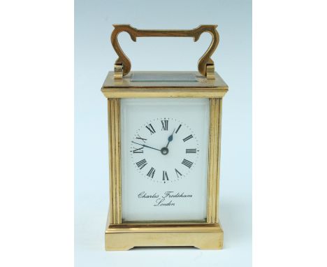 A late 20th Century brass carriage clock, key wind and set, the case having fluted square corners and bevelled glass, the whi