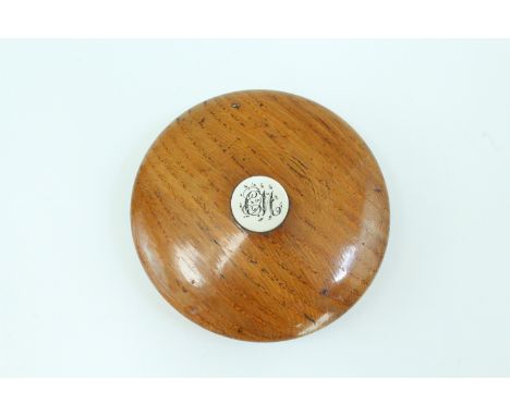 A late Victorian turned oak snuff box, of drum form with domed slip-lid, the latter bearing an inset mother-of-pearl escutche