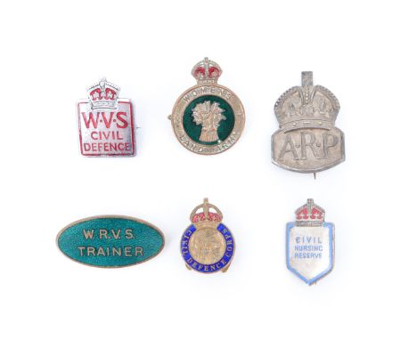 A Women's Land Army cap badge together with a silver ARP badge, a WRVS Trainer enamelled lapel and other badges