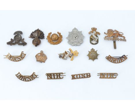 A small group of British army cap and other badges including a Lancashire Fusiliers officer's Service Dress badge