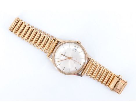 A 1980s Garrard 9 ct gold automatic gentleman's wristwatch, having a 21 jewel Swiss movement, a silver dial with baton marker