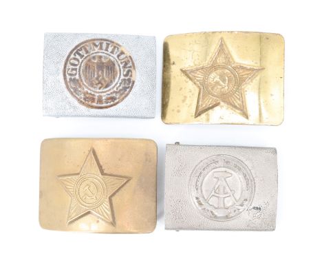 Two Soviet belt buckles together with a Cold War era East German army belt buckle and a replica buckle