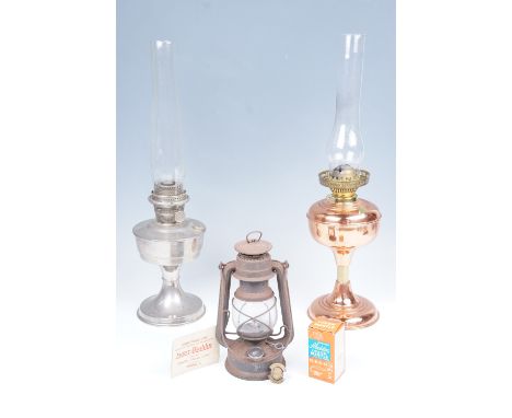 A late 20th Century copper oil lamp, a nickel plated oil lamp with spare mantles, and a paraffin hurricane lamp, oil lamps 60