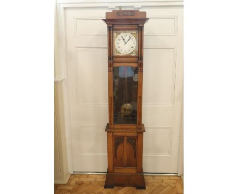 An Arts and Crafts / jugendstihl influenced oak long case clock, having an 8-day weight-driven two-train movement striking on