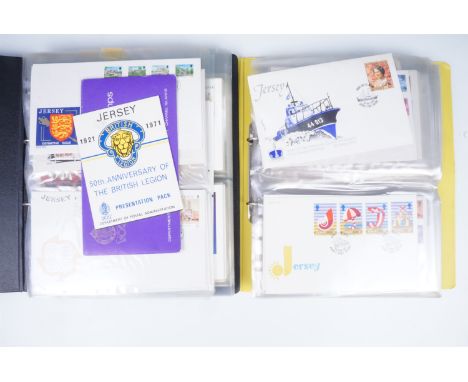 Two albums of QEII Jersey first day covers, together with specimen stamps etc