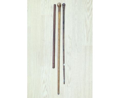 A hide swagger stick together with an early 20th Century hide swagger cane with loaded pommel, 76 cm, and one other stick