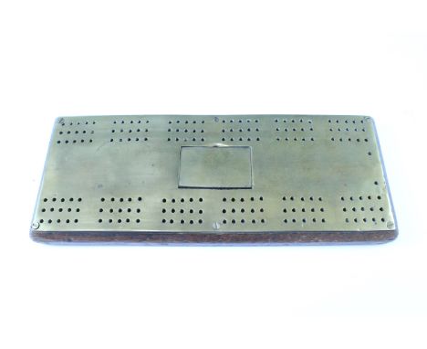 A 19th Century brass and oak cribbage board, having a central hinged lid peg container