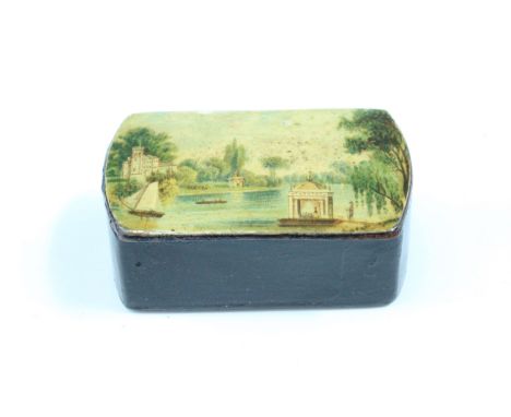 A Victorian lacquered pocket snuff box, its hinged lid decorated in depiction of a lake with boats, a classical temple and ca