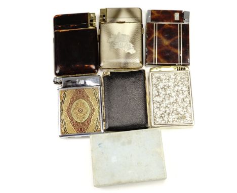 A group of vintage combination cigarette case and lighters, including one bound in gilt tooled leather, one bearing a Cold Wa