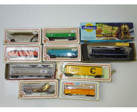 HO GAUGE MODEL RAILWAYS: A quantity of American Outline rolling stock to include: a diesel loco by ATHEARN and wagons by BACH
