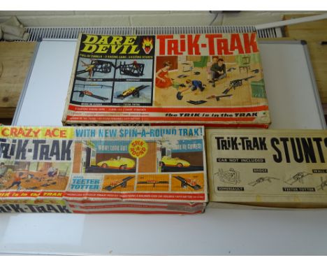 VINTAGE TOYS: A TRI-ANG Trik-Trak Daredevil set together with a Trik-Trak stunts set and a Trik-Trak Crazy Ace set  - G in F/
