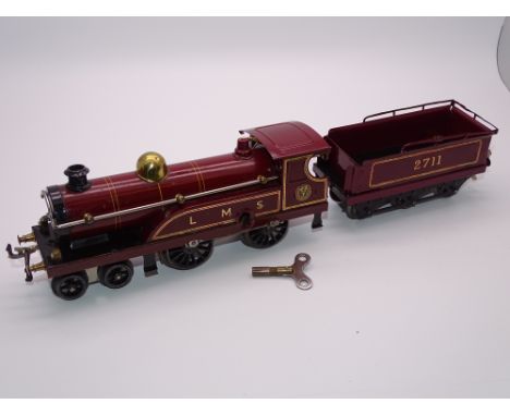 O GAUGE MODEL RAILWAYS: A HORNBY Series clockwork No. 2 LMS 4-4-0 locomotive and tender numbered 2711 - some retouching and v