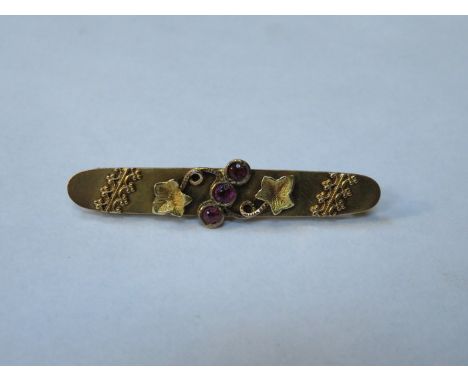 PRETTY VICTORIAN STYLE 9ct GOLD BAR BROOCH SET WITH THREE SMALL RUBY COLOURED STONES 