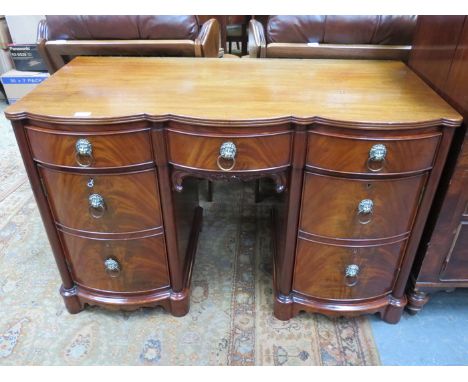 ANTIQUE MAHOGANY TRIPLE BOW FRONTED KNEEHOLE WRITING DESK WITH SINGLE DRAWER, TWO CUPBOARD DOORS AND BRASS LIONS HEAD HANDLES