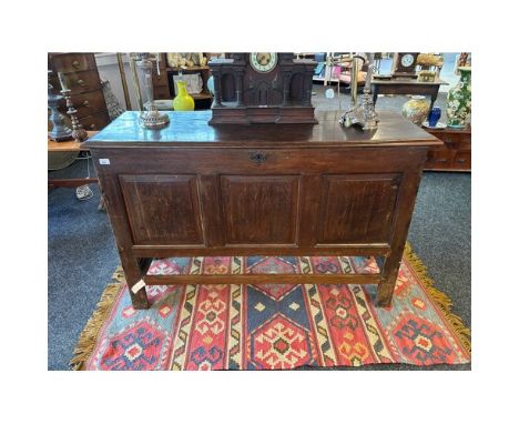 Antique oak coffer, the rectangular lift up surface above a panel front, raised on block legs