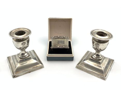 Silver napkin ring (25g) and a pair of Silver Neo Classical style candlesticks (Weighted, 8cm tall)