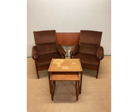 A pair of 1970s teak framed upholstered lounge chairs, two G-Plan Quadrille teak tables and a teak double headboard, width 13