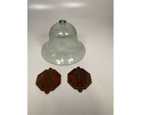 A vintage glass bell cloche, height 28cm and a pair of iron clock faces, width 16cm.