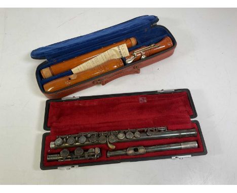 Two musical instruments including a flute and a Yamaha recorder, both cased.