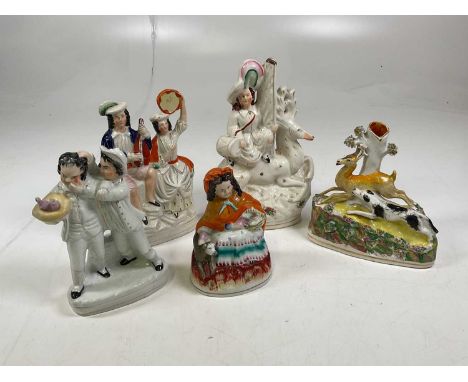 A collection of five Staffordshire ceramic flatback figures including a dog and deer.