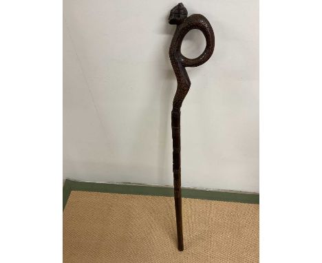An early 20th century Trobriand Islands carved stick, length 106cm.