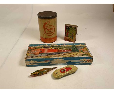 A collection of vintage clockwork toys and advertising tins including a Sharps Super-Kreem toffee tin, a Chad Valley money bo