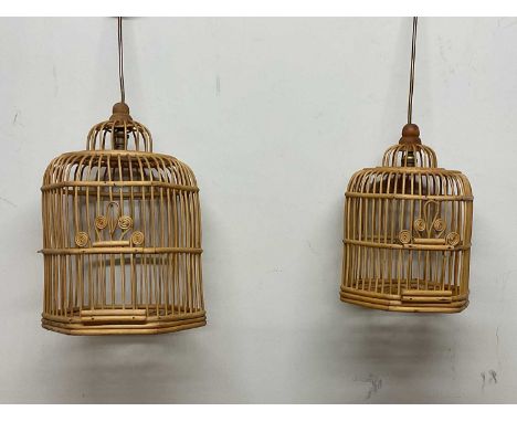 A pair of vintage mid 20th century cane work bird cages converted into pendant lights, largest height 42cm.
