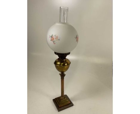 A brass Corinthian column oil lamp with opaque shade, height including chimney 70cm.