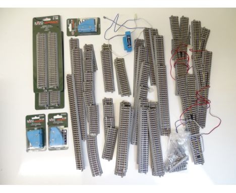 HO SCALE MODEL RAILWAYS: A quantity of boxed and unboxed track and accessories by KATO including points and straights - VG in