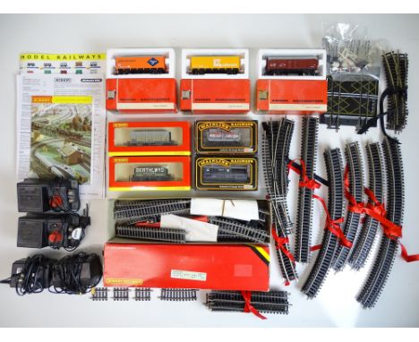 OO SCALE MODEL RAILWAYS: A group of rolling stock, track and accessories by HORNBY and MAINLINE - together with 3 x HO SCALE 