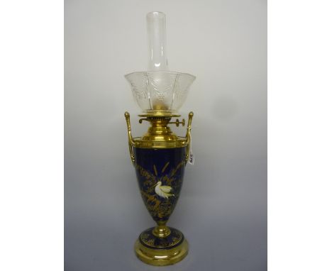 A COBALT BLUE URN SHAPED OIL LAMP, with hand painted Crane decoration and gilt foliage, with glass funnel and shade, height a