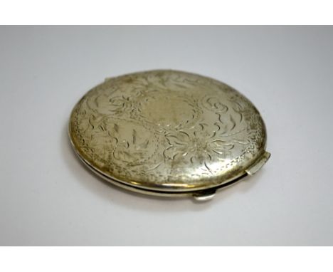 A COMPACT MIRROR, with flower engraving to the top, stamped 'STERLING UP' 