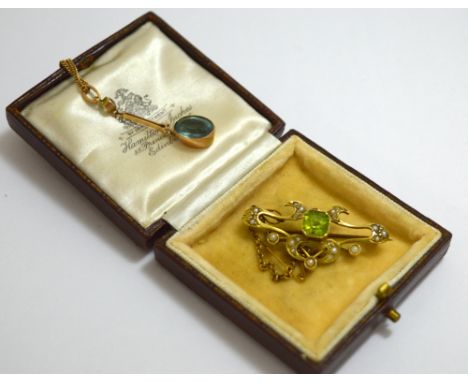 TWO TURN OF THE CENTURY PIECES OF JEWELLERY, to include an aquamarine pendant necklace, together with a peridot and split pea