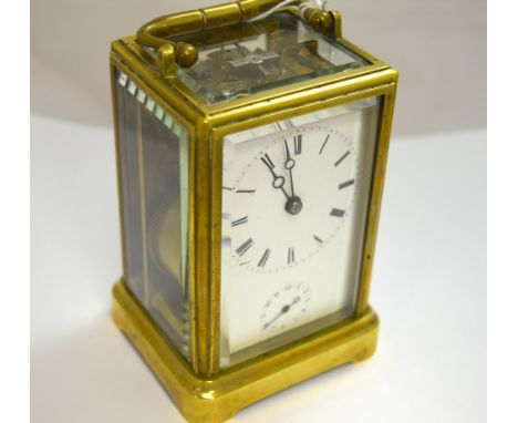 A SMALL BRASS CARRIAGE CLOCK, with white dial to three glass sides (key)