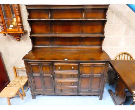 An Ercol sideboard with shelved display back, four central drawers flanked by panelled doors 