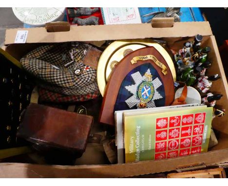 A mixed lot of Militaria to include cloth caps with badges, ceramic soldiers, shield, tray, badge collectors books sighting s